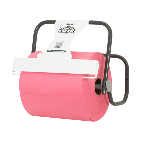 Pro Strength T800 red jumbo roll wiper mounted in a dispenser for easy tear-off in commercial and industrial settings.