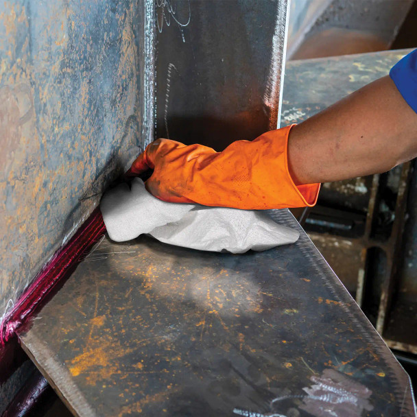 Pro Strength T600 white wiper towel being used to clean industrial equipment or work surface in a workshop.