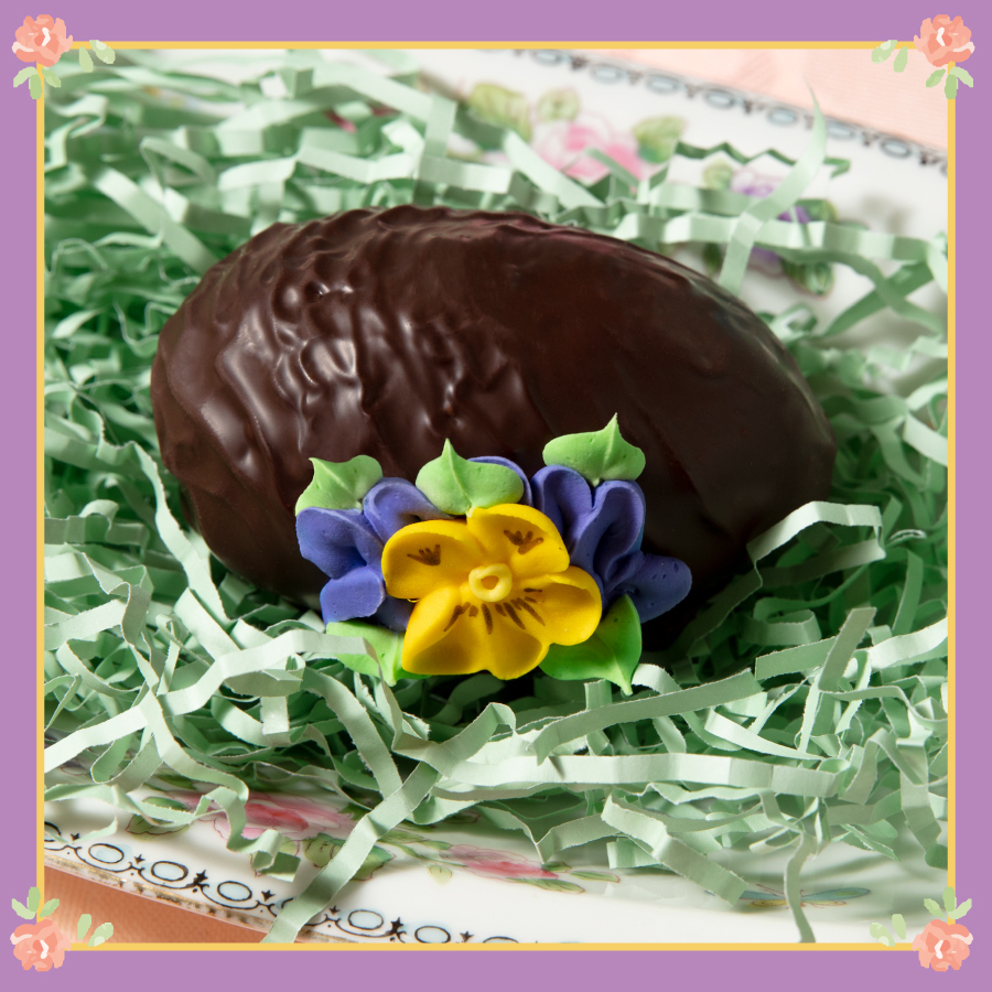 Hand-Decorated Fudge Egg in Dark Chocolate on Green Easter Shred