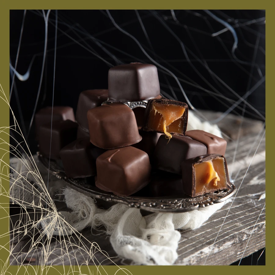 Cream Caramels in Milk & Dark Chocolate, on a platter with spider webs