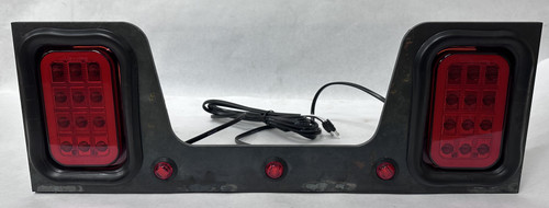 Dual Maxxima LED stop turn tail light bracket assembly for dump truck rear lighting applications with integrated marker lights and fabricated steel bracket.