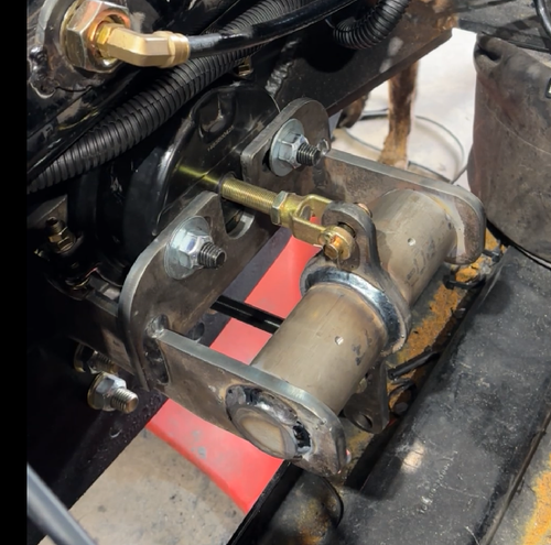 Don Dens Sales pintle hook air compensator relocator showing the mounting arrangement and linkage behind the pintle plate.