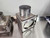 Stainless steel 5in-to-4in reducer adapter with hardware, used for adapting 4" exhaust systems to fit 5" heat kit diverter box and spring plate.