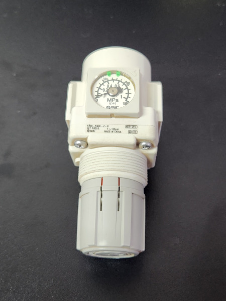 SMC 158 air regulator with integrated pressure gauge and 1/4 in NPT port, rated for 60 PSI maximum output pressure.