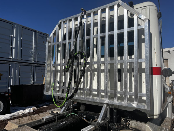 Don Dens Sales standard aluminum headache rack with gussets and reinforced 2x4" tubing, mounted on flatbed truck.