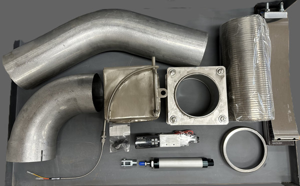 Complete exhaust diverter kit for heating dump boxes, including diverter valve, exhaust elbows, flex tubing, clamps, and control components for cold weather dump truck operation.