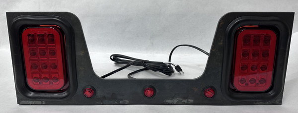Dual Maxxima LED stop turn tail light bracket assembly for dump truck rear lighting applications with integrated marker lights and fabricated steel bracket.