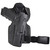 A black handgun is positioned inside a tactical holster with a belt attachment, designed for secure carrying, set against a plain white background.