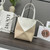 Loewe A657V25X01  Mini Puzzle Fold tote in shiny calfskin Apricot White