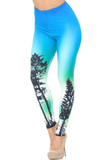 Angled front view image of our gorgeous Creamy Soft Blue Sunset Leggings - USA Fashion™ featuring a colorful blue and green ombre star-filled night sky design with tree silhouettes.