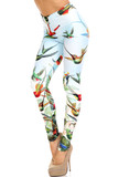 45 degree view of Creamy Soft Happy Hummingbirds Plus Size Leggings - USA Fashion™ with an amazing colorful bird design contrasting a light blue background.
