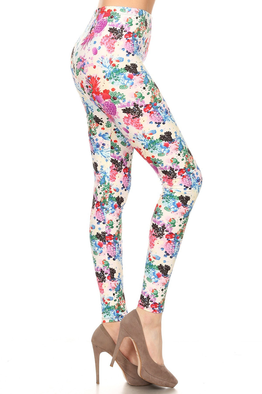 Right side view image of Buttery Smooth Ivory Fruit Bunch Plus Size Leggings featuring a colorful print of abstract style pineapples and grapes, atop a white background.