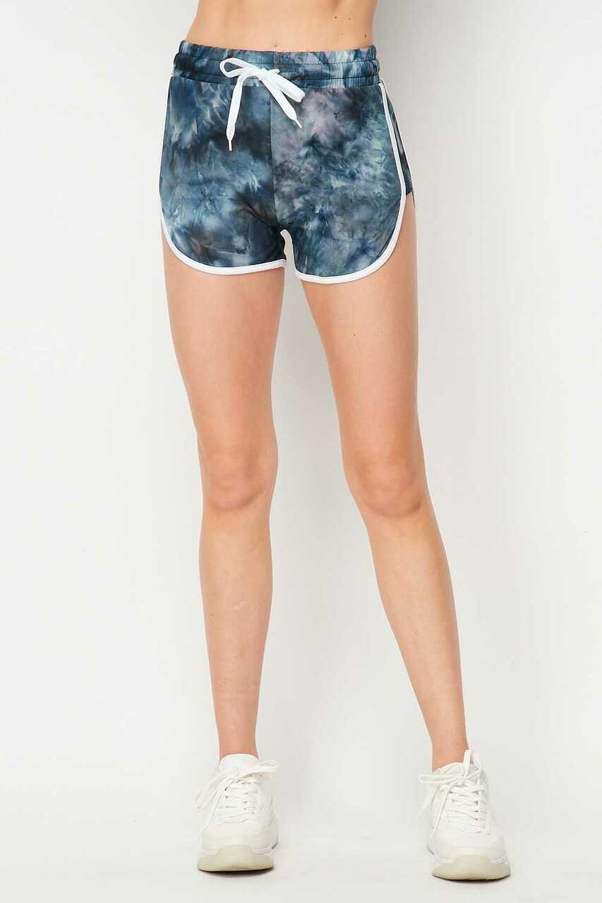 Front of Buttery Soft Navy Tie Dye Side Striped Drawstring Waist Dolphin Short shown paired with white sneakers