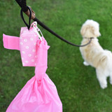 Tie handle dog poop  bags in duffel waste bag dispenser with used, tied bag clipped on the metal carabiner clip