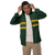 Front view of a guy in a lightweight, hooded windbreaker — featuring an abstract base pattern with dark green & gold stripes