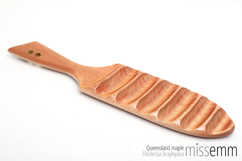 Handmade spanking toys | BDSM wooden paddle | Created by Australian kink artisan Miss Emm. This paddle is made from Queensland maple with brass details. It features a smooth face and ridged face which allows for two very different sensations. If you love unique fetish toys then this spanking paddle will be right at home in your fetish toy box.  