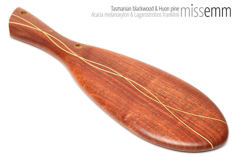 Unique handcrafted bdsm toys | Oval spanking paddle | By kink artisan Miss Emm | Made from Tasmanian blackwood with Huon pine lines and brass details | A subtle spanking toy for the discerning kinkster.