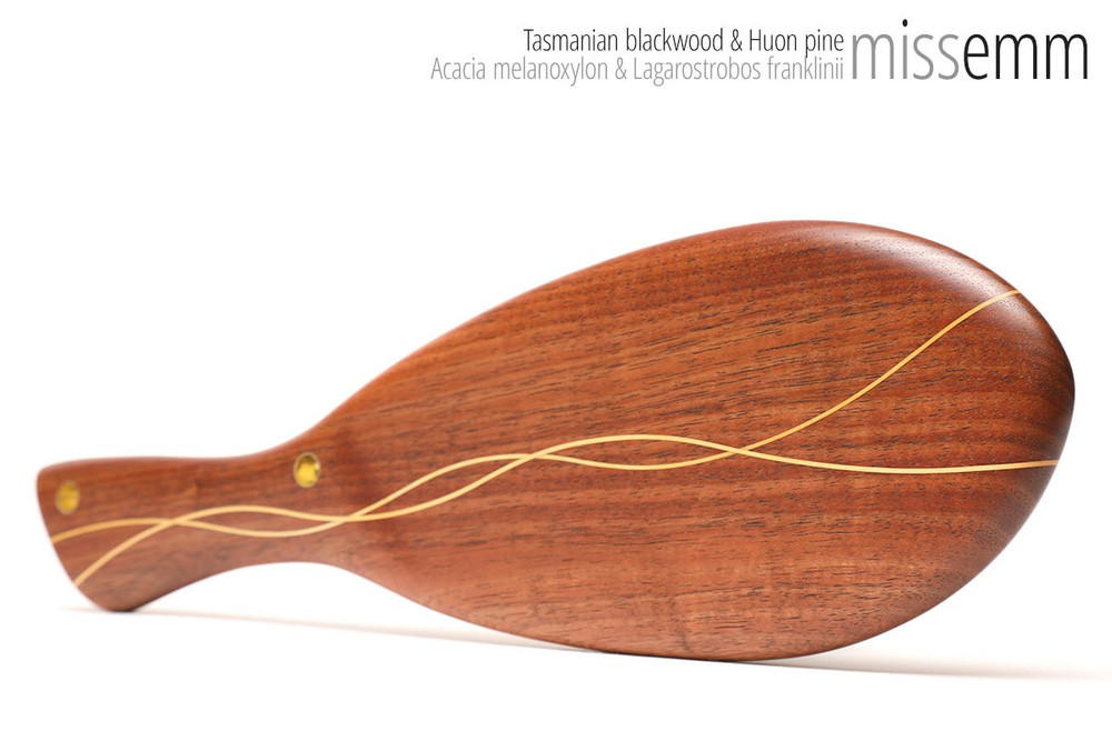 Unique handcrafted bdsm toys | Oval spanking paddle | By kink artisan Miss Emm | Made from Tasmanian blackwood with Huon pine lines and brass details | A subtle spanking toy for the discerning kinkster.