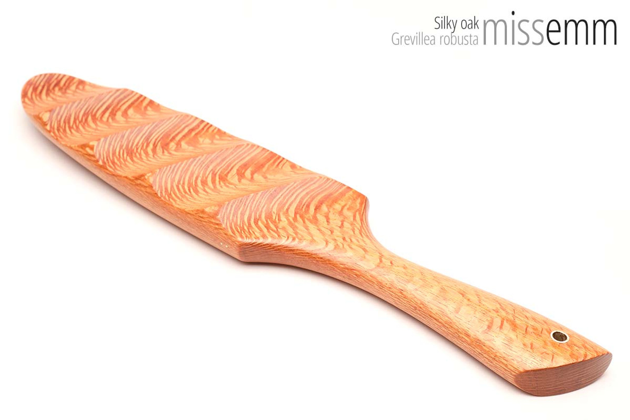 Unique handcrafted bdsm toys | Wooden spanking paddle | By kink artisan Miss Emm | Made from Silky oak with brass details.