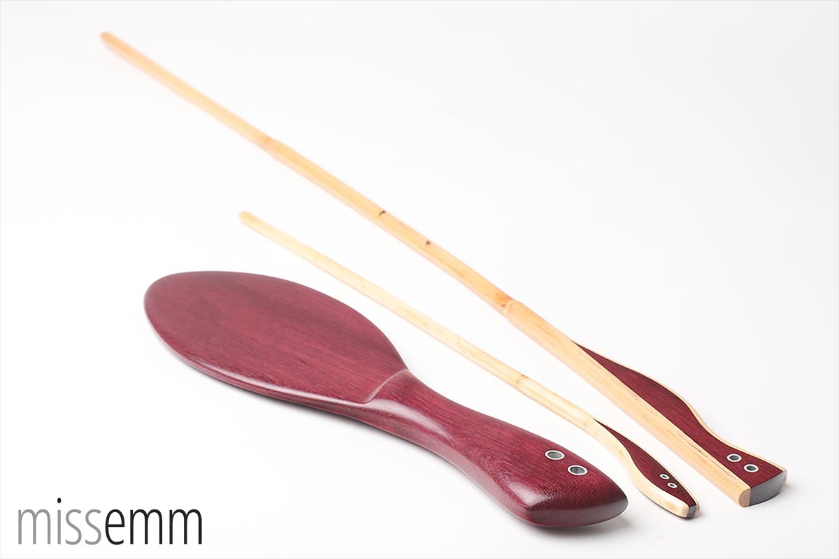 Purpleheart spanking paddle and two canes created as a matching set by fetish artisan Miss Emm