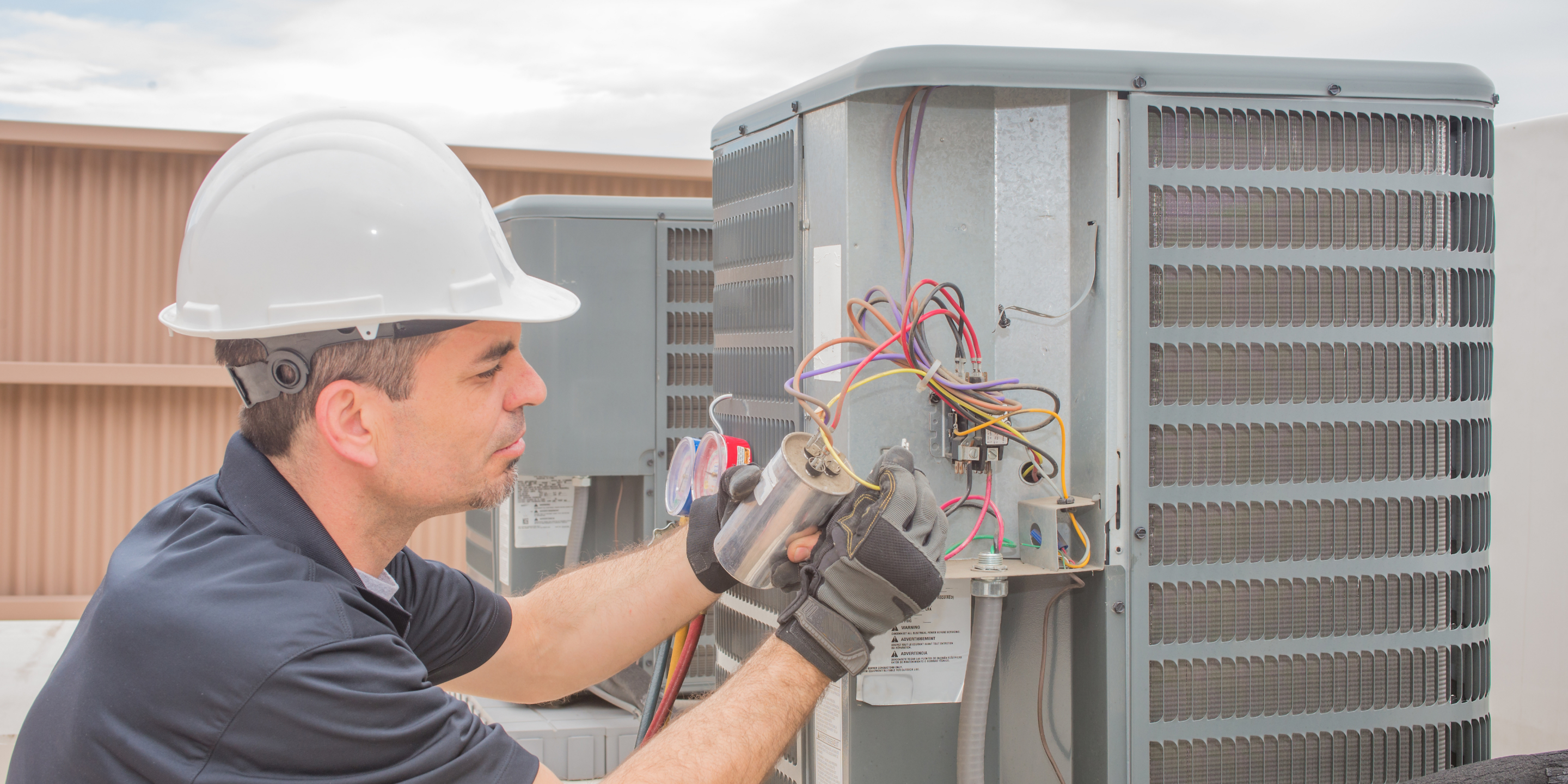 man working on air conditioning
                    machinery