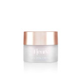 A frosted glass jar of cream with a rose gold lid, labeled "Fleur's GOLDEN CREAM."