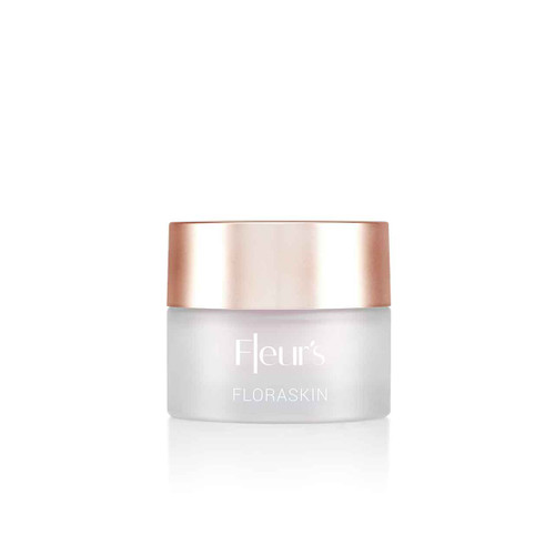 A frosted glass jar of skincare cream with a rose gold lid, labeled "Fleur's FLORASKIN."