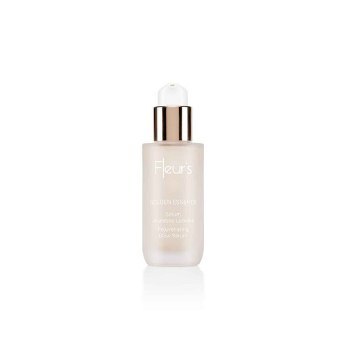 A clear serum bottle with a gold cap, labeled "Fleur's Golden Essence Rejuvenating Glow Serum."