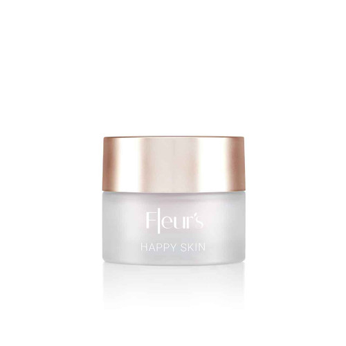 A small jar of cream labeled "Fleur's HAPPY SKIN" with a frosted glass body and a gold lid.