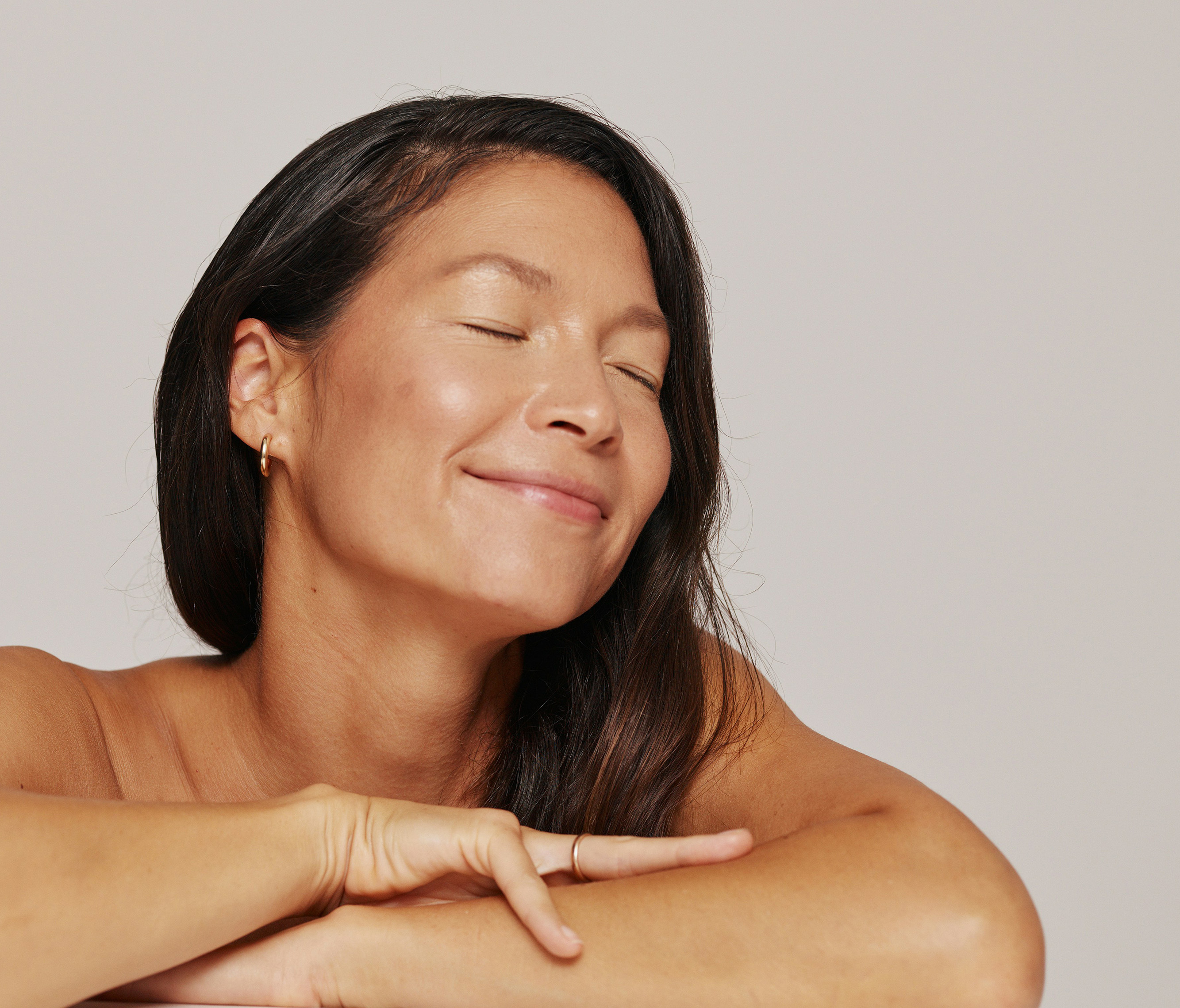 Woman smiling with her eyes closed.