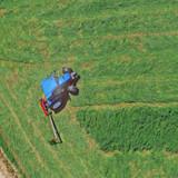 Farm-Maxx FSBM-7H 84-inch hydraulic fold sickle bar mower attached to compact tractor cutting hay field