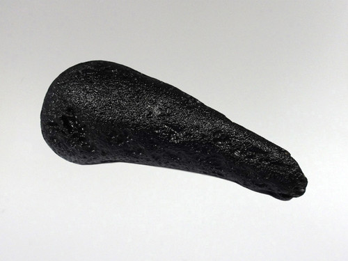 Tektites are natural glass rocks that are formed from terrestrial debris ejected during extraterrestrial impacts.