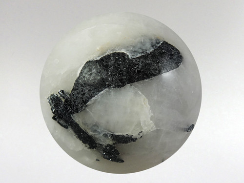 Beautiful white quartz sphere with rods of black tourmaline inclusions.