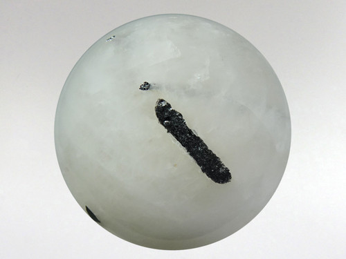 Gorgeous white quartz sphere with rods of black tourmaline inclusions.