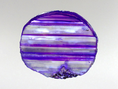 This agate slice has been photographed with light behind it to help emphasize its attributes.