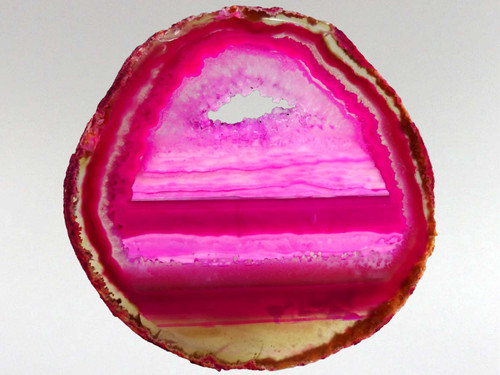 This beautiful pink agate slice has been photographed with light behind it to help emphasize its attributes.