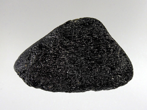 Tektites are natural glass rocks that are formed from terrestrial debris ejected during extraterrestrial impacts.
