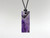 Amethyst dream flat rectangle pendant on black waxed cord.