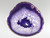 This violet agate slice has been photographed with light behind it to help emphasize its attributes.