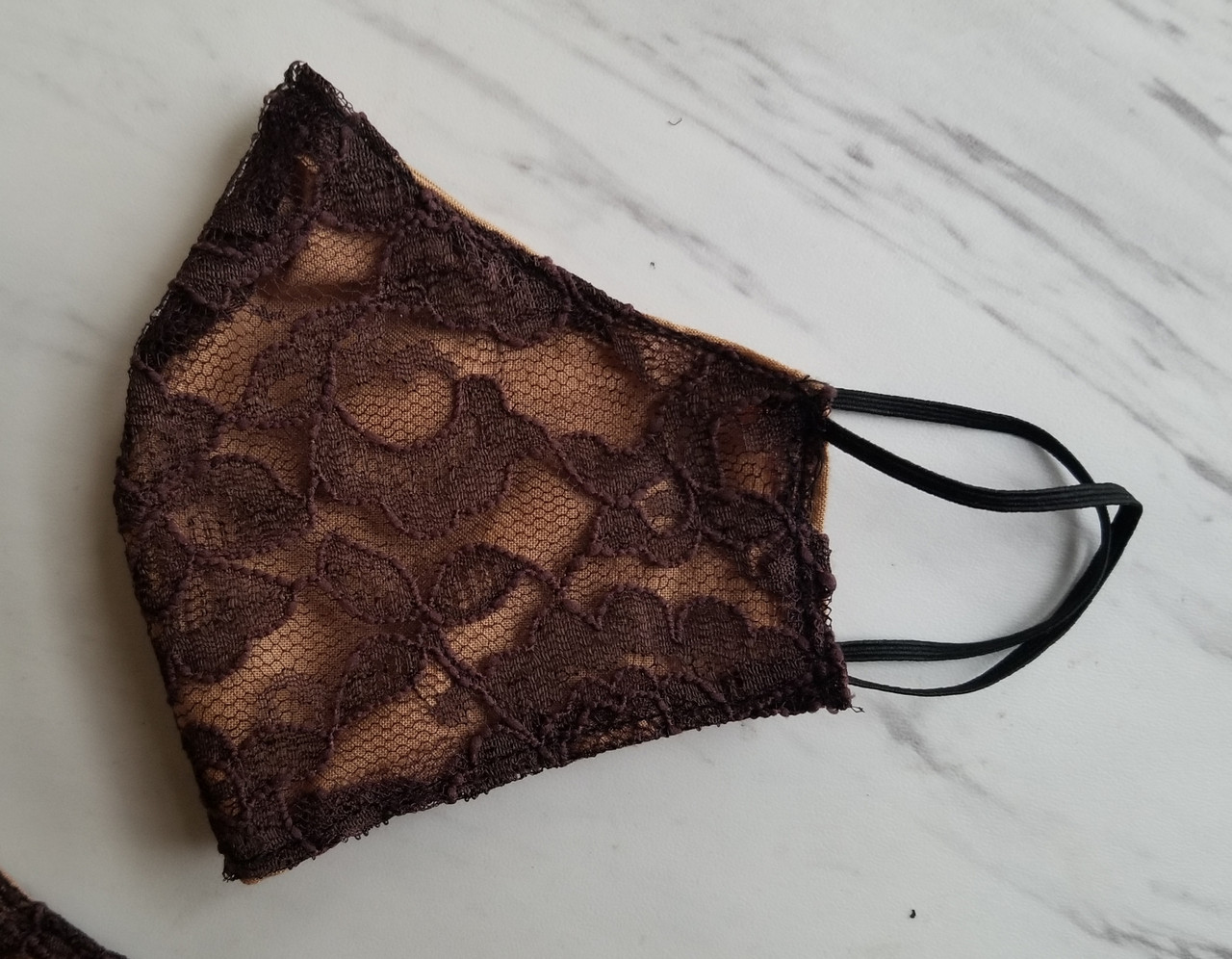 Brown lace facemask w tan background 