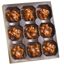 Lammes Candies Texas Chewie Pecan Pralines showcased in a gold-trimmed tray, highlighting their rich, caramel-coated pecan perfection.