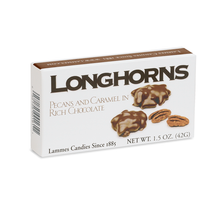 The Lammes Candies Milk Chocolate Longhorns box features a clean white design with bold black lettering, showcasing images of pecan and caramel clusters coated in rich milk chocolate.