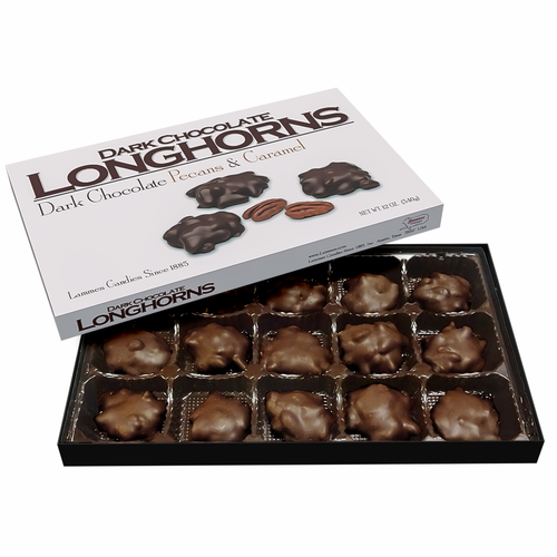 Open box of Lammes Candies Dark Chocolate Pecan Caramel Longhorns Candies featuring rich, dark chocolate-coated treats with pecans and caramel, arranged neatly in individual trays.