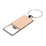 A drink bottle opener keytag with a bamboo design and a silver metal key ring.
