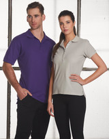 A man in a purple polo shirt and a woman in a grey polo shirt, both with collars, standing side by side.