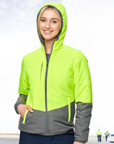 A woman wearing a Hi-Vis quilted two-tone safety jacket in fluorescent yellow and grey, featuring a hood and zipped pockets.