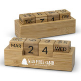 A bamboo desk calendar featuring wooden blocks for days and months, with a logo displayed on the base. A bamboo desk calendar featuring wooden blocks for days and months, with a logo displayed on the base.