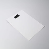 A flat, white magnetic calendar with a black tab at the top. The design is simple and minimalistic.