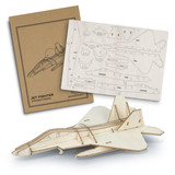 A wooden model of a jet fighter in light wood tones, alongside a die-cut sheet and packaging with a logo.