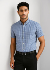 A short-sleeve button-up shirt in blue and white gingham pattern, featuring a collar and a logo.